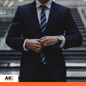 Mężczyzna w garniturze przygotowujący się do spotkania, symbolizujący profesjonalizm i zarządzanie kadrami.